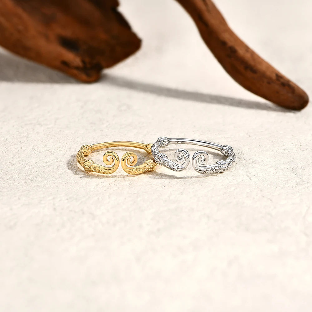 Polished sterling silver ring paired with a classic gold ring