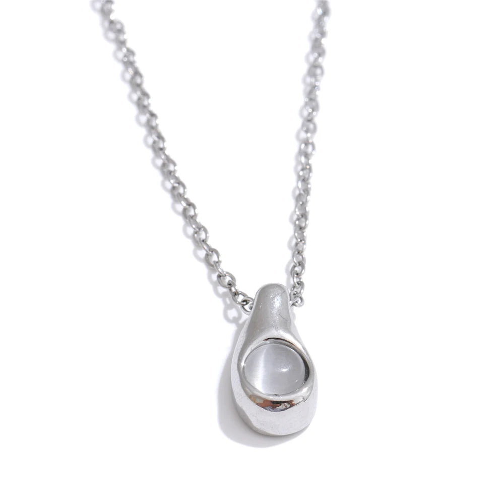 Fashion shot showing women with necklace wearing cat eye pendant