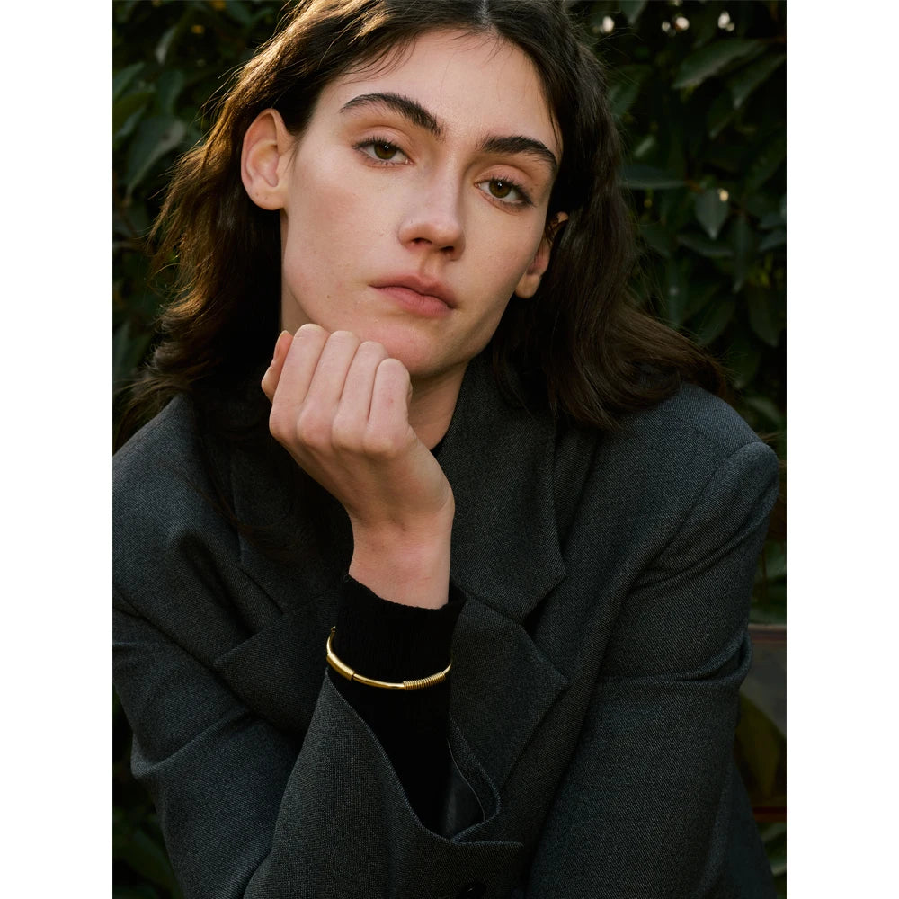 Open bangle bracelet styled with bracelet bracelets for a polished stack