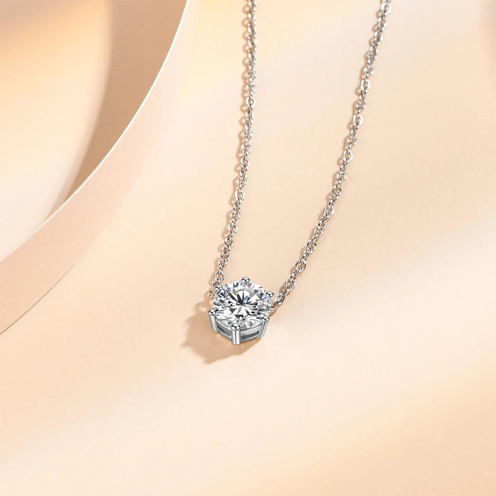 Charm necklace style featuring a round cut moissanite in sterling silver