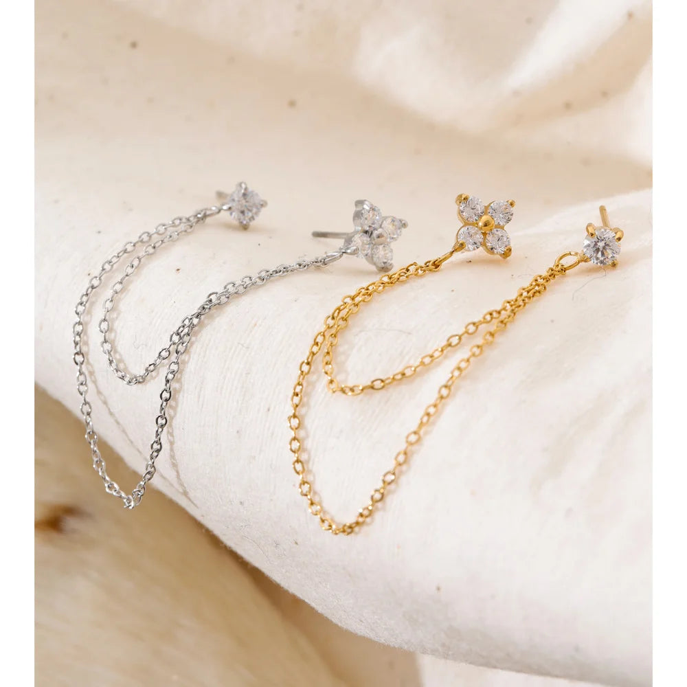 Close up of drop earrings gold with floral zirconia sparkle