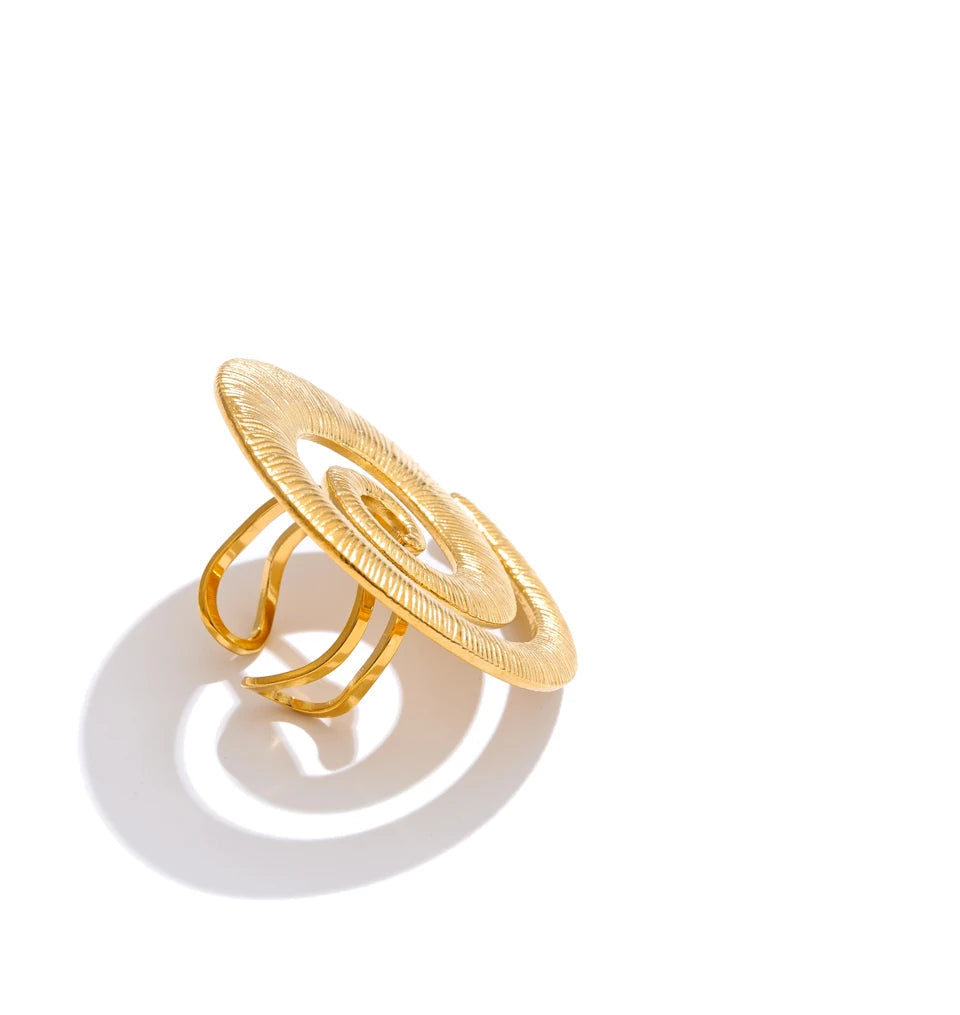 Side angle of twisted geometric open ring highlighting the texture detail