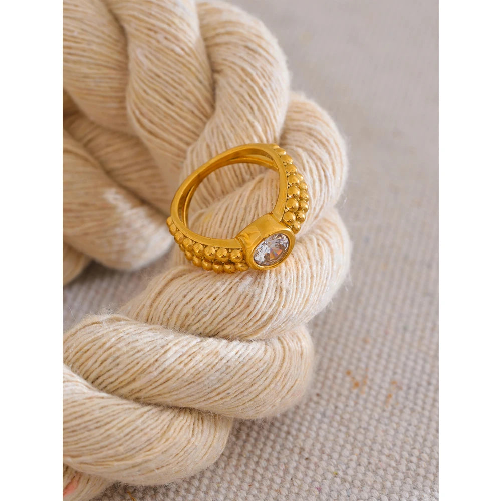 Gold ring paired with stainless steel metal rings for contrast