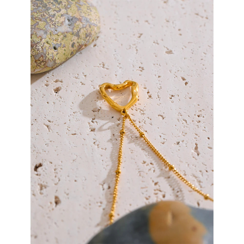 Close view of necklace heart motif styled as necklace with gold layers