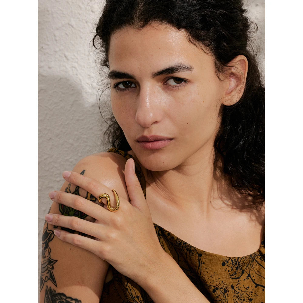 Minimalist stainless steel jewelry ring with gold plated finish on a finger