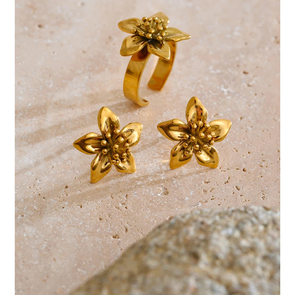 Golden golden earrings styled next to ring jewelry gold for a coordinated look