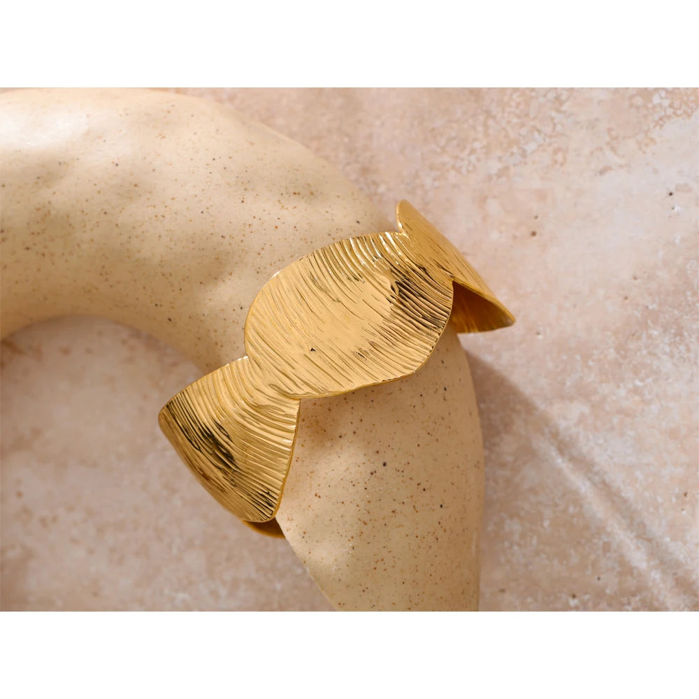 Close view of cuff bracelet with gold plated finish for golden jewelry glow