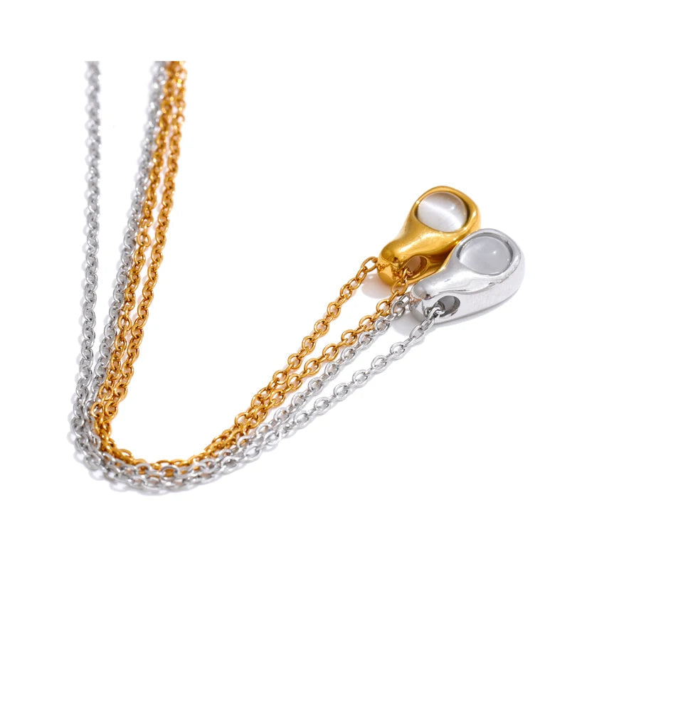 Cat eye stone pendant highlighted in stainless steel jewelry finish