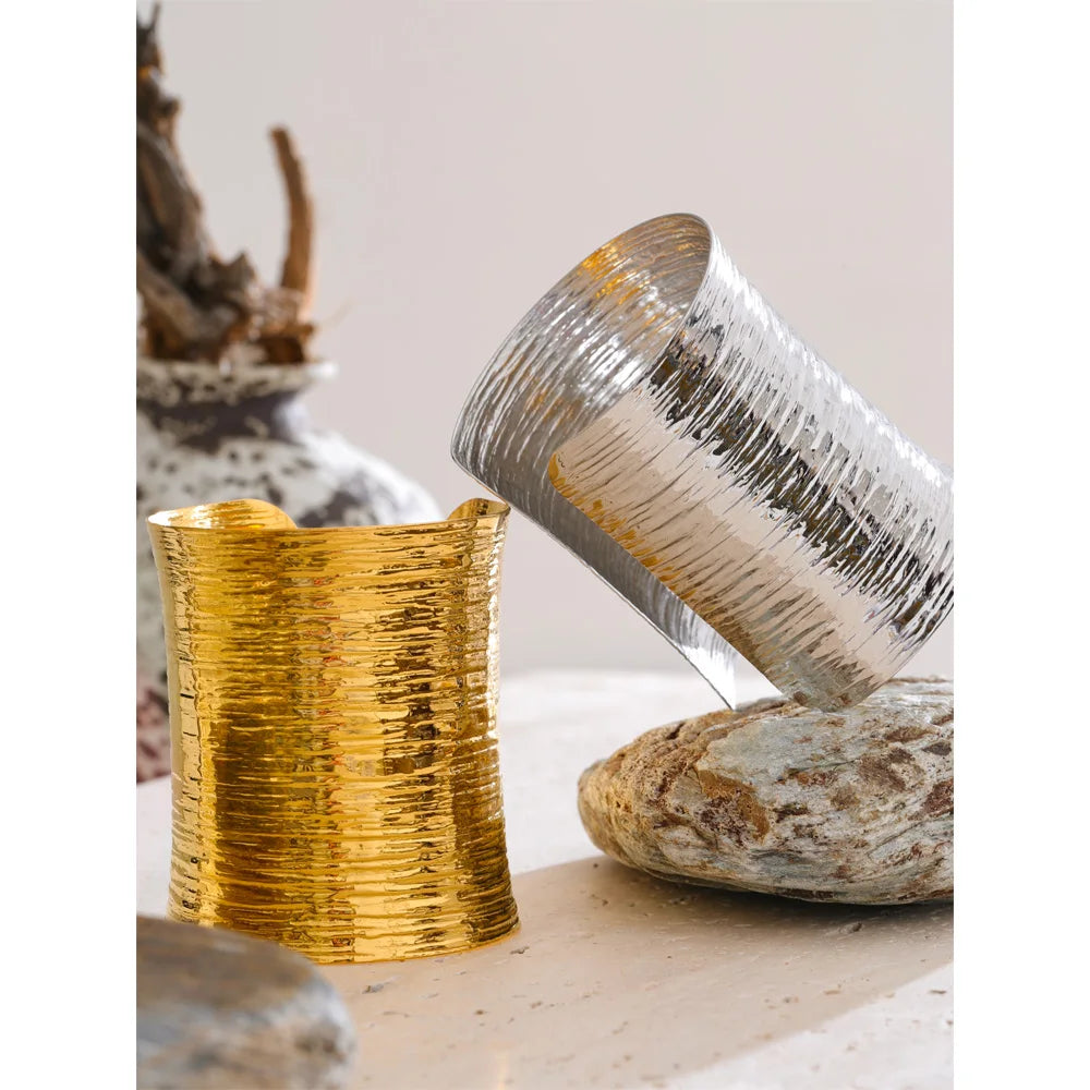 Close view of bracelet with gold detailing on a sculpted bangle