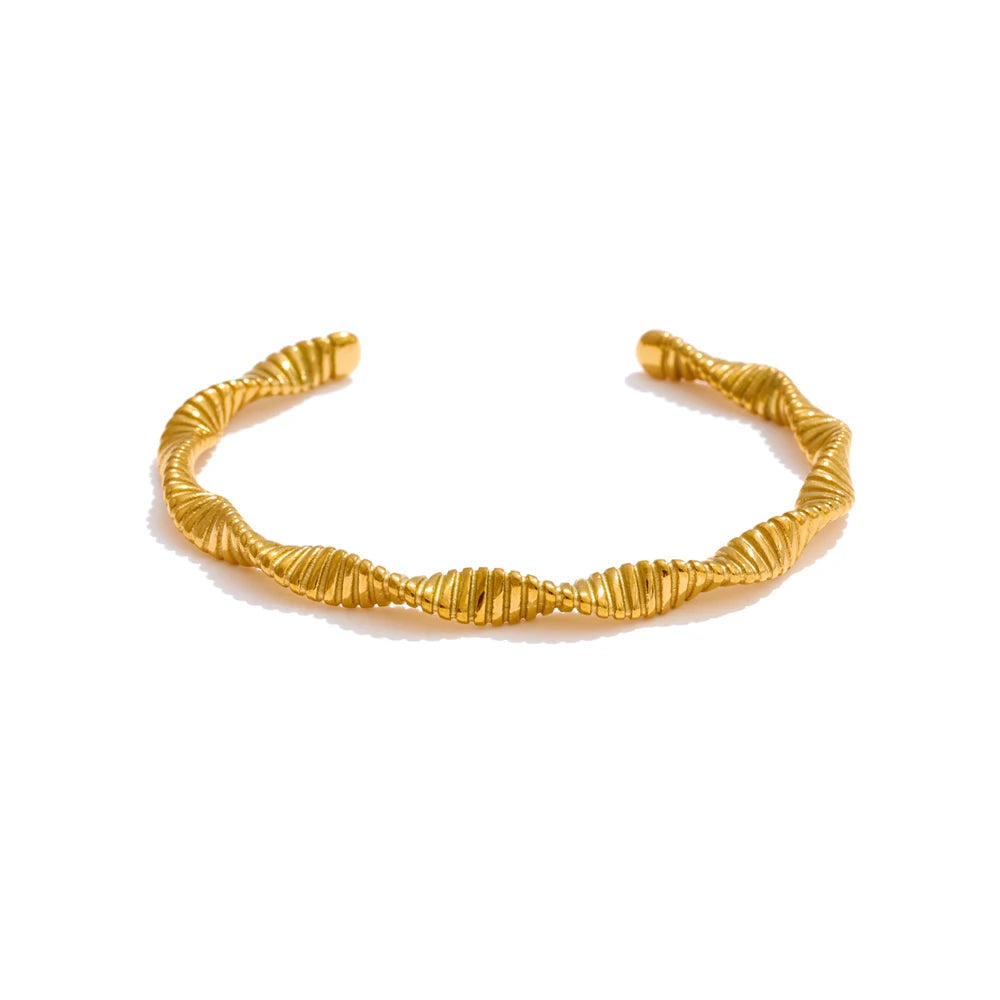 Twisted cuff bracelet with gold plated shine styled as a bangle bracelet
