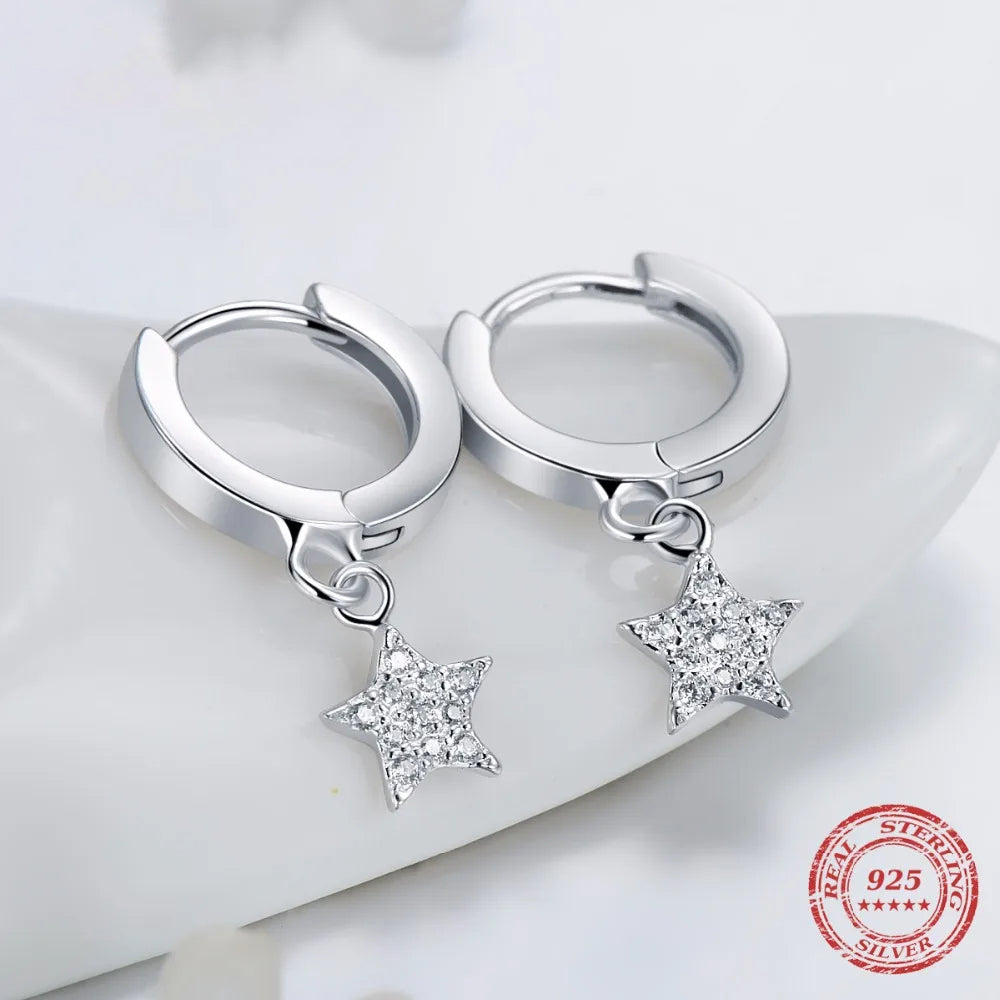 Silver color heart earrings paired with stars earrings