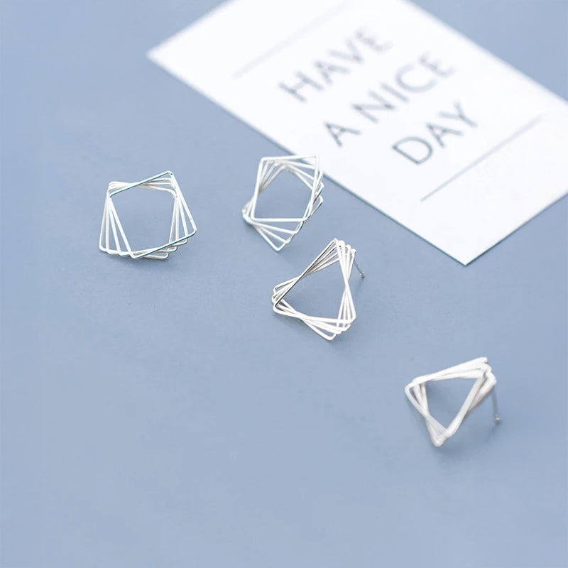 Pair of ear rings featuring sleek triangle and square outlines